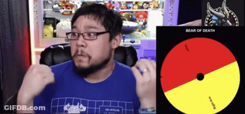 A Man Wearing Glasses And A Blue Shirt Is Sitting In Front Of A Cd That Says Bear Of Death GIF