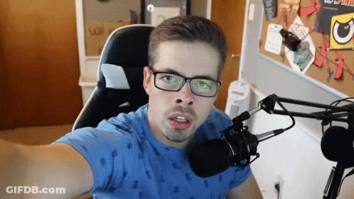 Man In Glasses And Blue Shirt Taking Selfie With Microphone GIF