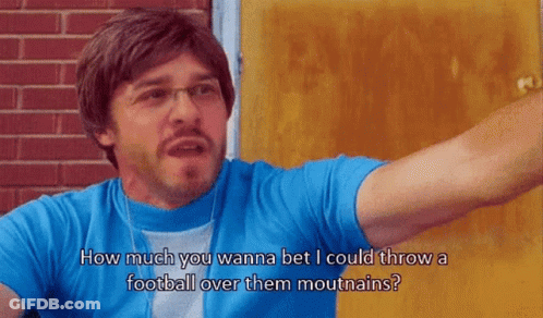 A Man Wearing Glasses And A Blue Shirt Says How Much You Wanna Bet I Could Throw A Football Over Them Mountains GIF