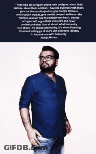 A Man Wearing Glasses And A Blue Shirt Stands In Front Of A Quote By Aishwarjit Naskar GIF
