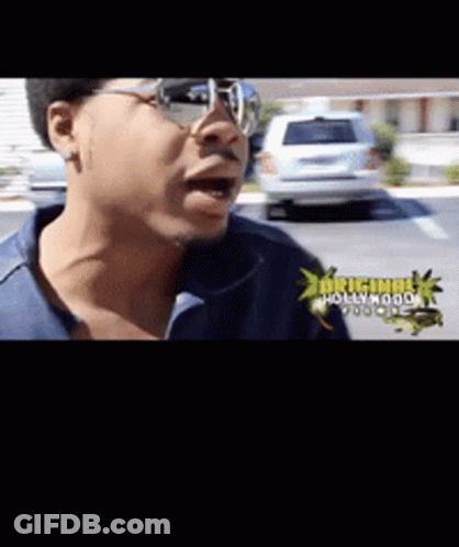 A Man Wearing Glasses And A Blue Shirt With The Words Original Hollywood On The Bottom GIF