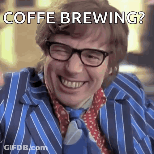 A Man Wearing Glasses And A Blue Striped Suit Is Smiling With The Words Coffe Brewing Below Him GIF