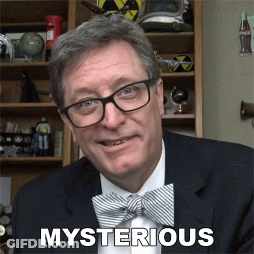 A Man Wearing Glasses And A Bow Tie Has The Word Mysterious Above His Head GIF