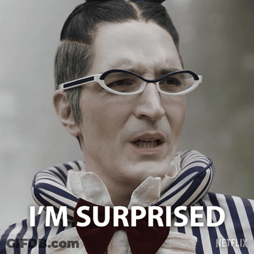 A Man Wearing Glasses And A Bow Tie Has The Words I 'M Surprised On His Face GIF