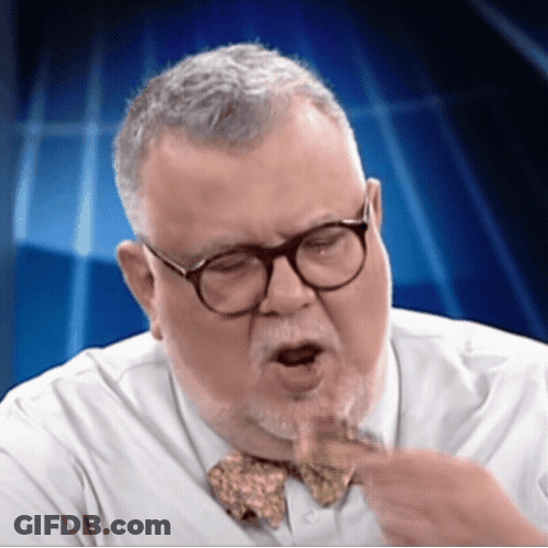 A Man Wearing Glasses And A Bow Tie Is Making A Face GIF