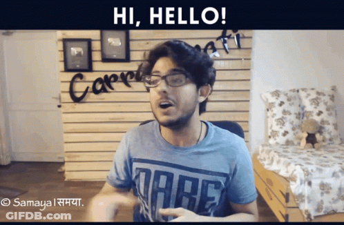 A Man Wearing Glasses And A Dare T-Shirt Is Saying Hi Hello GIF