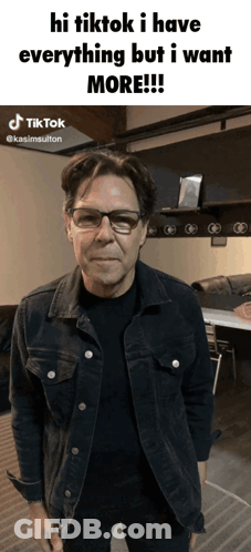 A Man Wearing Glasses And A Denim Jacket Says Hi Tiktok I Have Everything But I Want More .. GIF