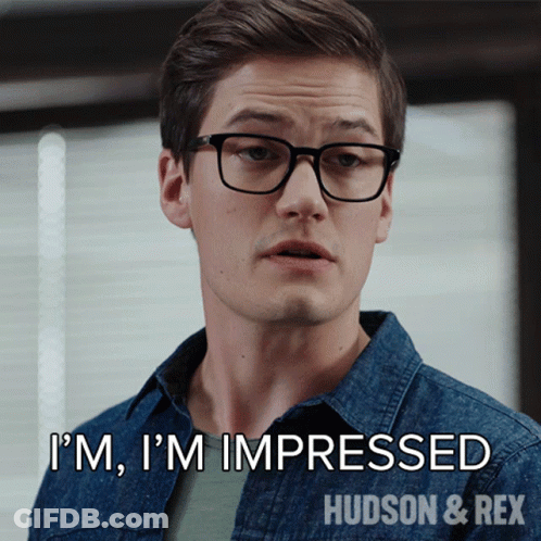 A Man Wearing Glasses And A Denim Shirt Says I 'M Impressed GIF