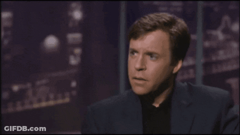A Man Wearing Glasses And A Fur Coat Is Talking About What The Hell Are You Talking About GIF