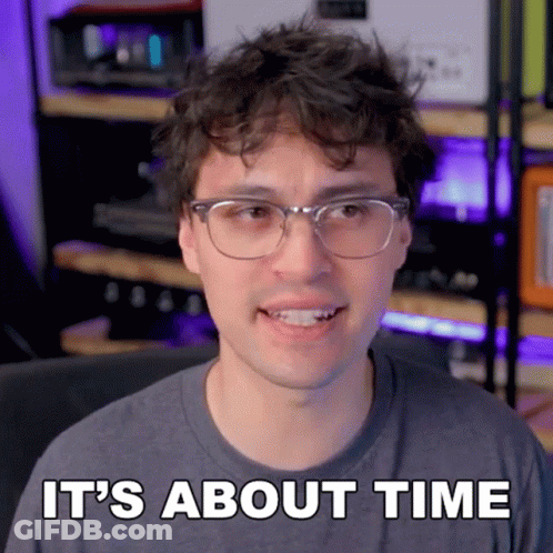 A Man Wearing Glasses And A Gray Shirt Says It 'S About Time GIF