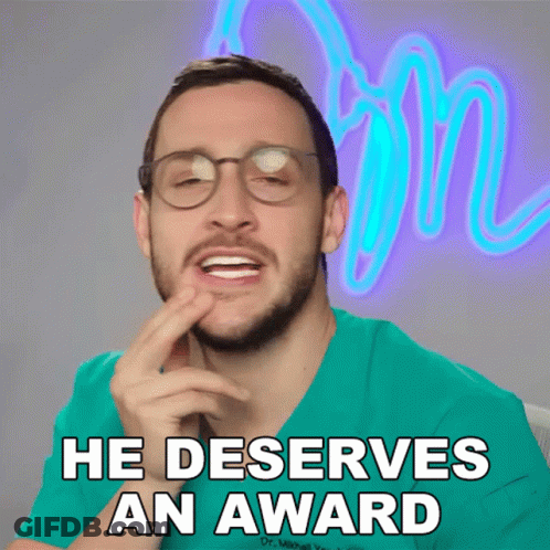 A Man Wearing Glasses And A Green Scrub Shirt Says He Deserves An Award GIF