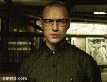 A Man Wearing Glasses And A Green Shirt Is Making A Face GIF