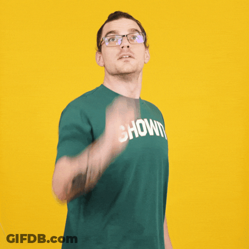A Man Wearing Glasses And A Green Shirt That Says Shown On It GIF