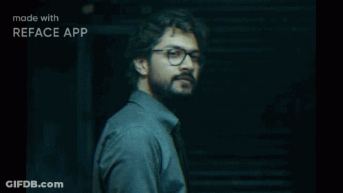 A Man Wearing Glasses And A Grey Shirt Is Made With Reface App GIF
