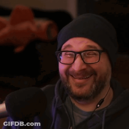 A Man Wearing Glasses And A Hat Gives Two Thumbs Up GIF