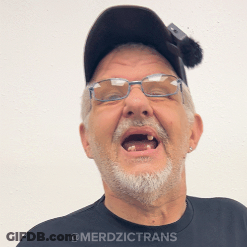 A Man Wearing Glasses And A Hat Has The Word Merdzictrans On The Bottom GIF