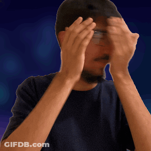 A Man Wearing Glasses And A Hat Is Covering His Face With His Hands GIF
