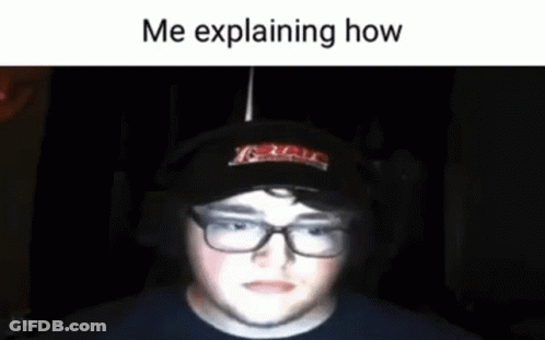 A Man Wearing Glasses And A Hat Is Explaining How He Is Playing A Game . GIF