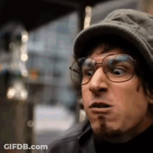 Man Wearing Glasses And Hat Making Surprised Face GIF