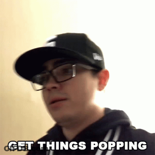 A Man Wearing Glasses And A Hat Is Saying Get Things Popping GIF