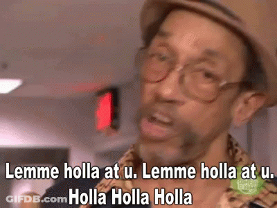 A Man Wearing Glasses And A Hat Is Saying Lemme Holla At U. GIF