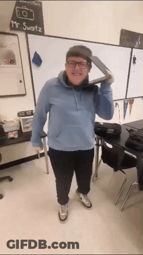 A Man Wearing Glasses And A Hat Is Standing In Front Of A White Board That Says Mr. Smartz GIF