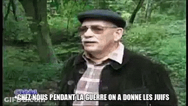 A Man Wearing Glasses And A Hat Is Standing In The Woods And Says Chez Nous GIF