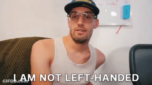 A Man Wearing Glasses And A Hat Says I Am Not Left Handed GIF