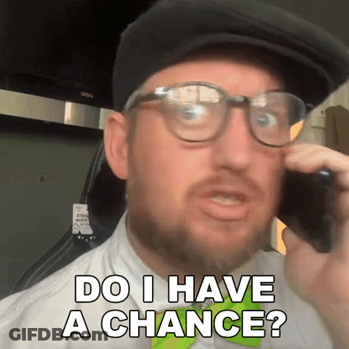 A Man Wearing Glasses And A Hat Talking On A Cell Phone With The Words Do I Have A Chance Below Him GIF