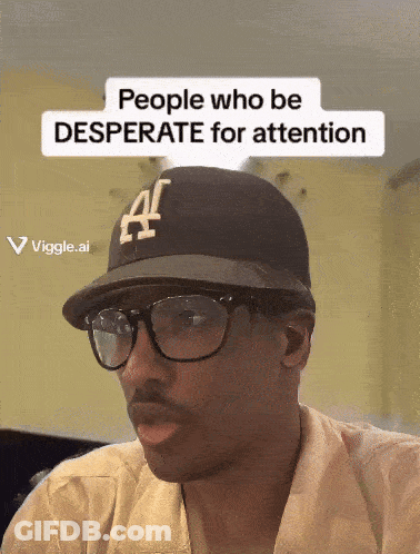 A Man Wearing Glasses And A Hat That Says ' People Who Be Desperate For Attention ' GIF