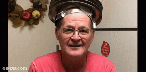 A Man Wearing Glasses And A Hat With A Red Sticker That Says Red Collar Society On It . GIF