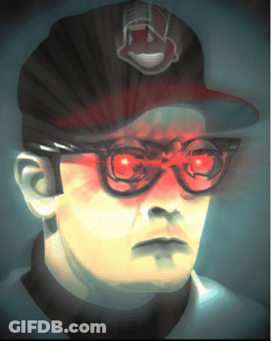 A Man Wearing Glasses And A Hat With The Indians Logo GIF