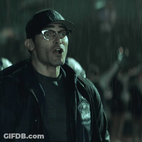 A Man Wearing Glasses And A Hat With The Letter B On It Is Making A Funny Face GIF