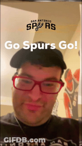 A Man Wearing Glasses And A Hat With The Words Go Spurs Go On The Bottom GIF