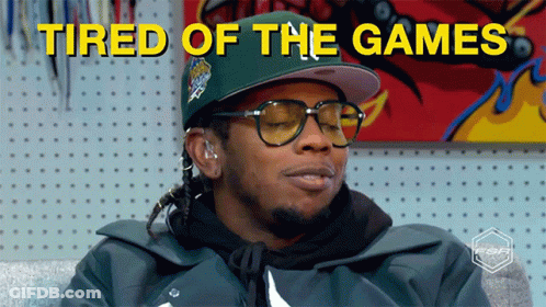 A Man Wearing Glasses And A Hat With The Words Tired Of The Games Above Him GIF
