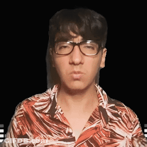 A Man Wearing Glasses And A Hawaiian Shirt Is Looking At The Camera GIF