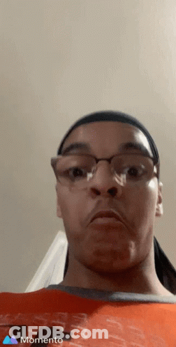 A Man Wearing Glasses And A Headband Is Making A Funny Face In A Momento Photo GIF