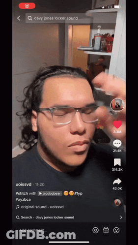 A Man Wearing Glasses And A Headband Is On A Tiktok Video GIF
