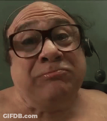 A Man Wearing Glasses And A Headset Is Eating Corn GIF