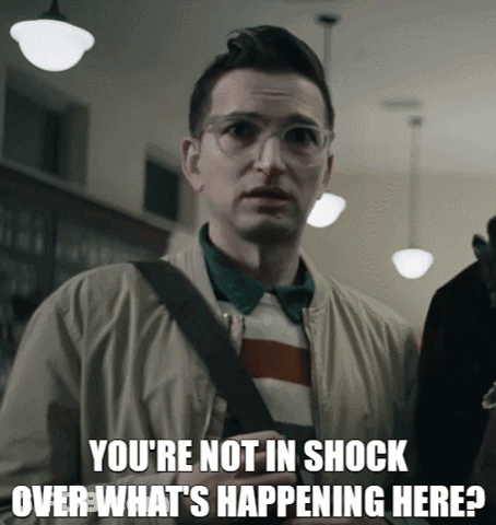 A Man Wearing Glasses And A Jacket Says You 'Re Not In Shock Over What 'S Happening Here GIF
