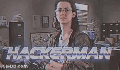 A Man Wearing Glasses And A Leather Jacket Is Standing In Front Of A Sign That Says Hackerman GIF