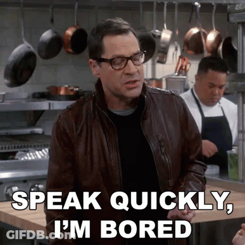 A Man Wearing Glasses And A Leather Jacket Says " Speak Quickly I 'M Bored " GIF