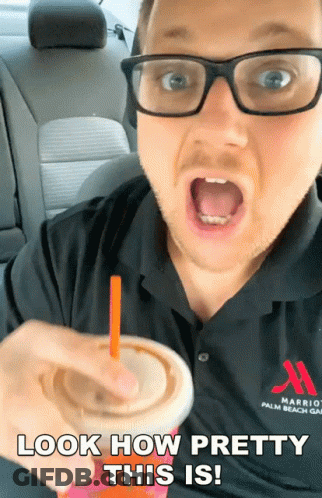 A Man Wearing Glasses And A Marriott Palm Beach Shirt Is Holding A Drink GIF