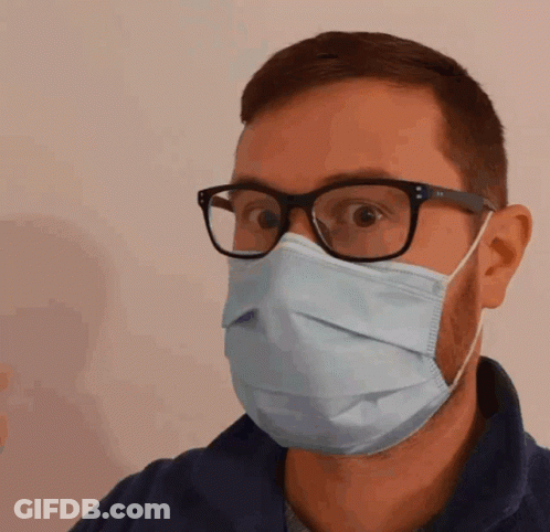 A Man Wearing Glasses And A Medical Mask GIF