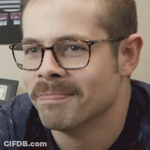 Man With Glasses And Mustache Looking At Camera GIF