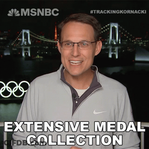 A Man Wearing Glasses And A Nike Jacket Is Smiling In Front Of A Bridge And The Words " Extensive Medal Collection " GIF