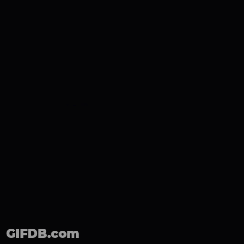 A Man Wearing Glasses And A Nike Shirt Is Making A Stop Gesture With His Hands . GIF