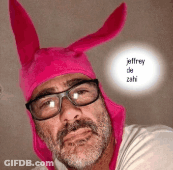 A Man Wearing Glasses And A Pink Hat With The Name Jeffrey De Zahi Written On It GIF