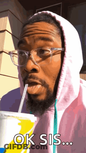 A Man Wearing Glasses And A Pink Hoodie Drinks Through A Straw And Says Ok Sis ... GIF