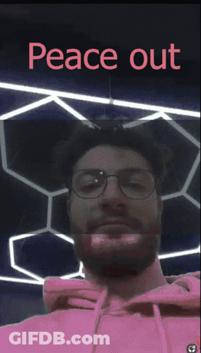 A Man Wearing Glasses And A Pink Hoodie With The Words Peace Out Written Above Him GIF